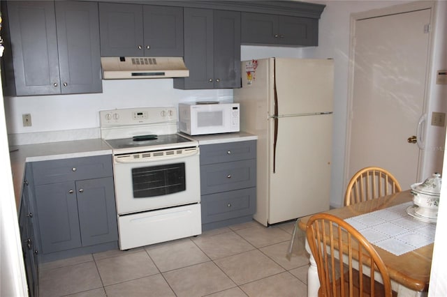 kitchen featuring gray cabinetry, white appliances, light countertops, light tile patterned floors, and extractor fan