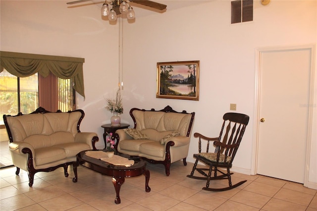 living area with light tile patterned floors, a ceiling fan, and visible vents