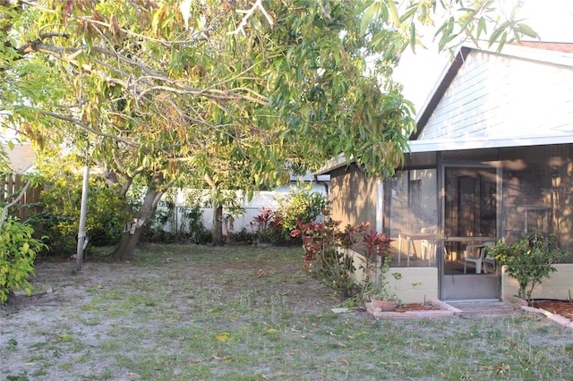 view of yard featuring a fenced backyard and a sunroom