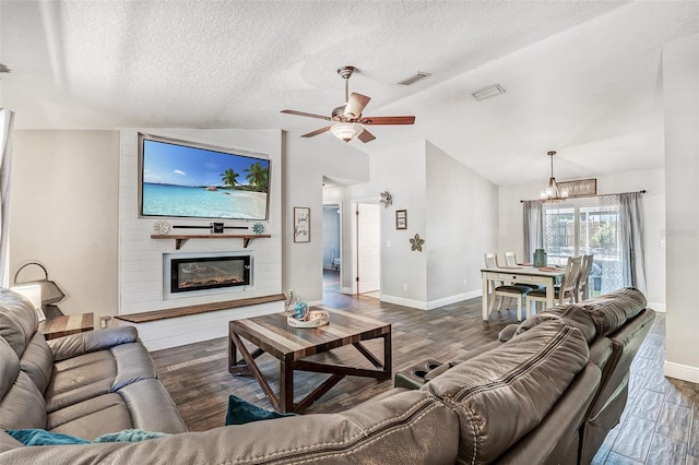 living area featuring visible vents, dark wood-style flooring, baseboards, and ceiling fan with notable chandelier