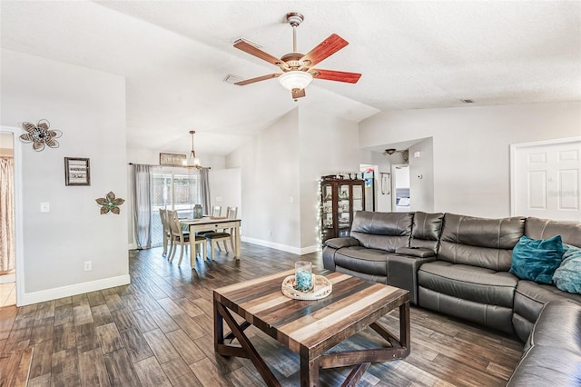 living room featuring baseboards, dark wood-type flooring, ceiling fan with notable chandelier, and vaulted ceiling