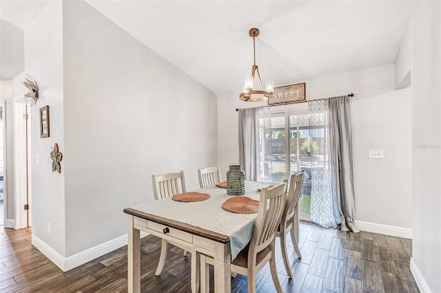 dining space featuring baseboards and wood finished floors