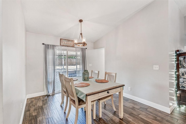 dining area with dark wood-style flooring, baseboards, lofted ceiling, and a notable chandelier