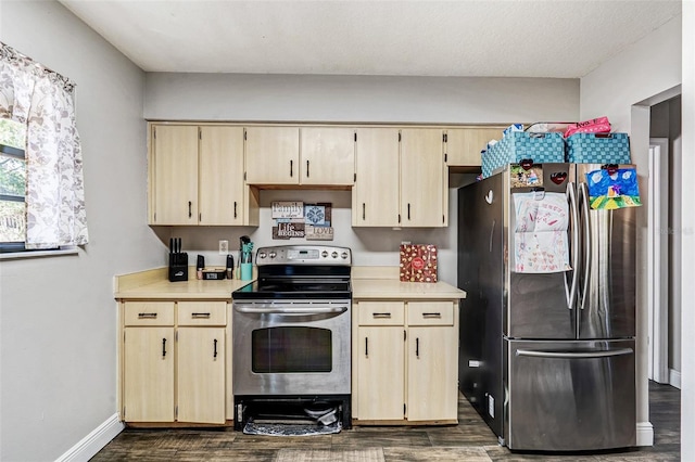kitchen with dark wood-style flooring, light countertops, and stainless steel appliances