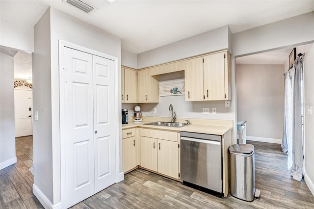 kitchen featuring light wood-style floors, visible vents, dishwasher, light countertops, and a sink