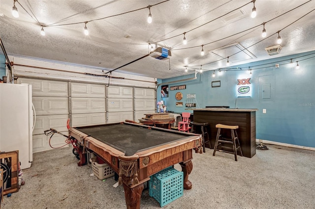 playroom with billiards, a dry bar, a garage, and a textured ceiling