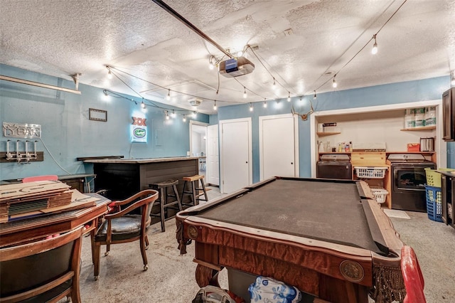 recreation room with pool table, track lighting, a textured ceiling, washer / dryer, and carpet
