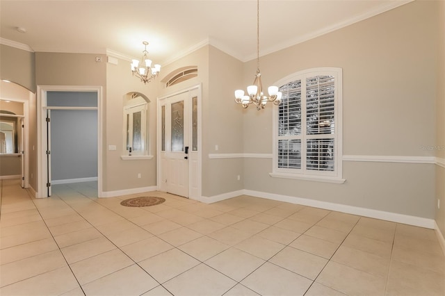 entrance foyer featuring light tile patterned floors, arched walkways, a notable chandelier, and crown molding