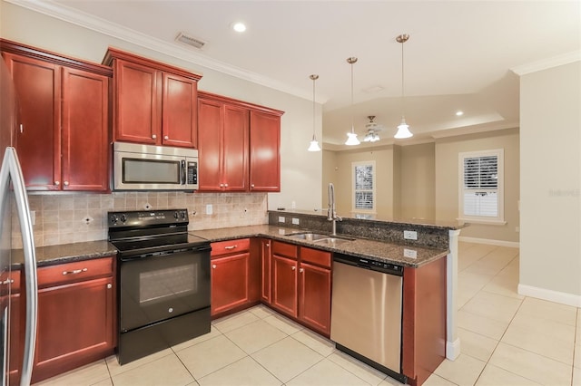 kitchen with dark brown cabinets, appliances with stainless steel finishes, ornamental molding, and a sink