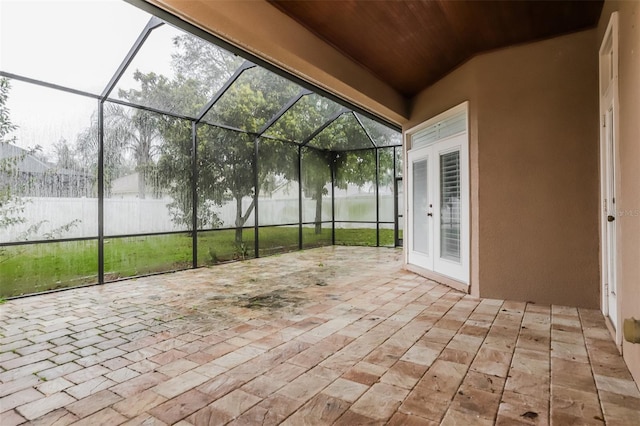 unfurnished sunroom with wooden ceiling and lofted ceiling