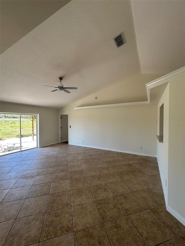 spare room with visible vents, dark tile patterned flooring, a ceiling fan, a textured ceiling, and vaulted ceiling