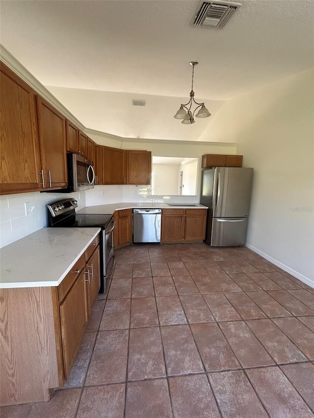 kitchen with brown cabinetry, visible vents, stainless steel appliances, hanging light fixtures, and backsplash