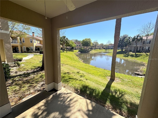 view of patio featuring a residential view and a water view