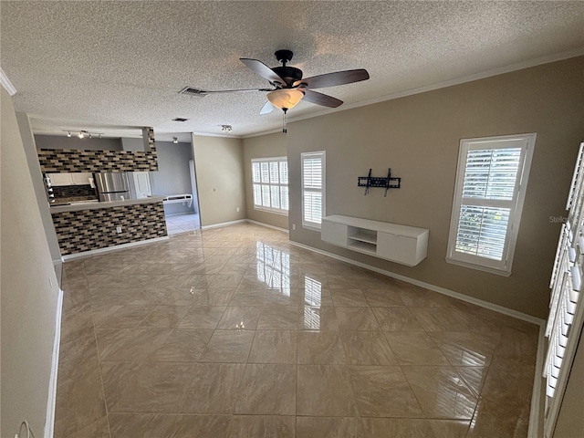 unfurnished living room featuring baseboards, a textured ceiling, a ceiling fan, and crown molding