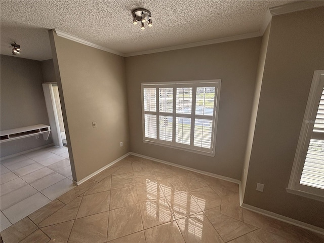 tiled spare room with a textured ceiling, baseboards, and ornamental molding