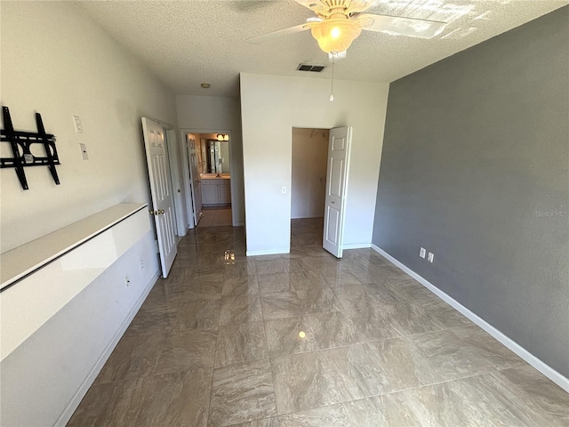 unfurnished bedroom with visible vents, a textured ceiling, baseboards, and a ceiling fan