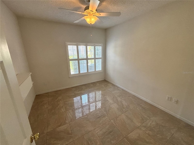 unfurnished room with baseboards, a textured ceiling, and a ceiling fan