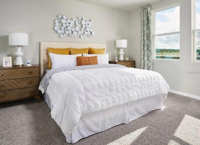 bedroom featuring baseboards and dark colored carpet