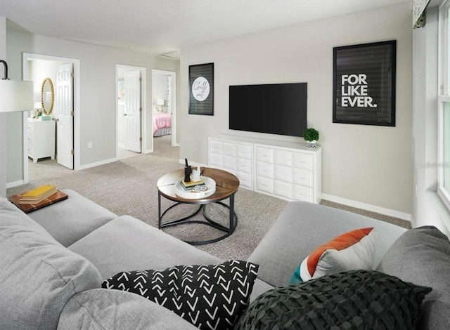 living room with baseboards and carpet