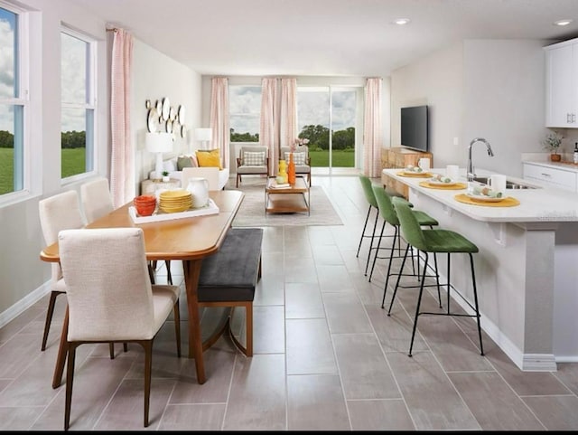 dining area with light tile patterned floors, recessed lighting, and baseboards