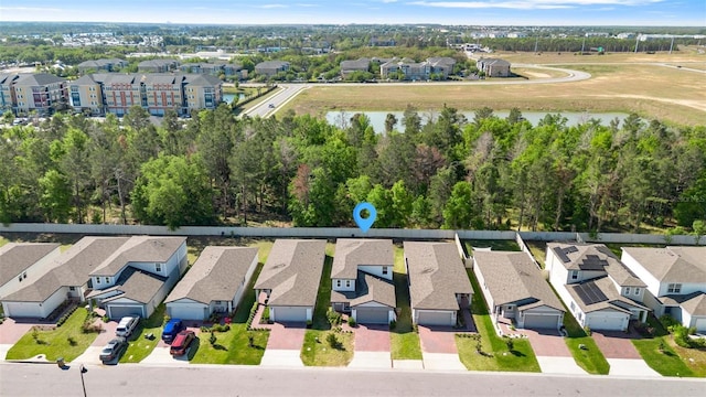 birds eye view of property with a water view and a residential view