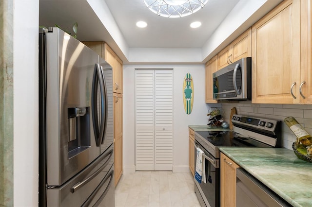 kitchen featuring light brown cabinetry, backsplash, recessed lighting, appliances with stainless steel finishes, and light countertops