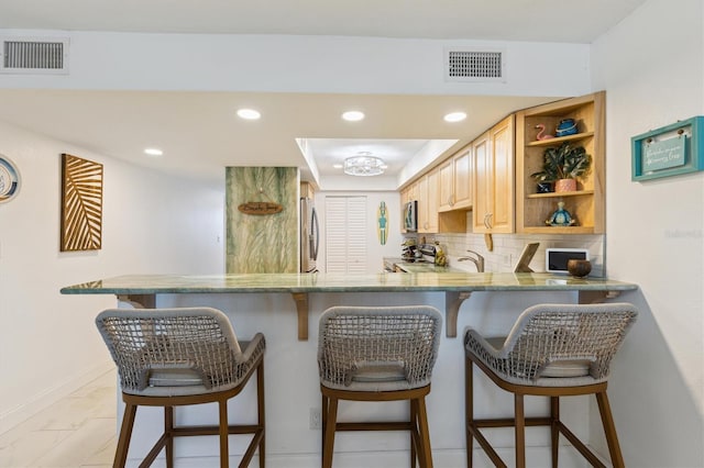 kitchen featuring open shelves, visible vents, backsplash, and appliances with stainless steel finishes