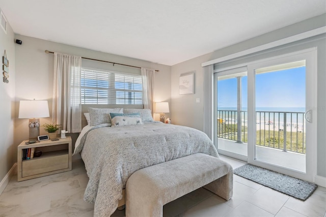 bedroom with access to outside, baseboards, and a water view