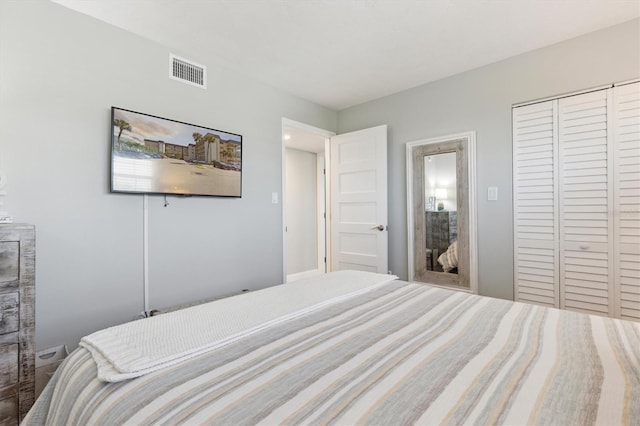 bedroom with a closet and visible vents