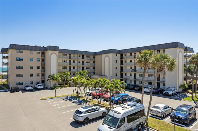 view of property featuring uncovered parking