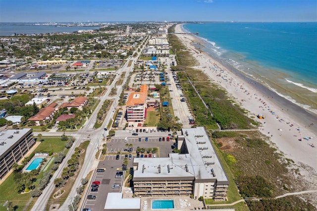 birds eye view of property with a beach view and a water view