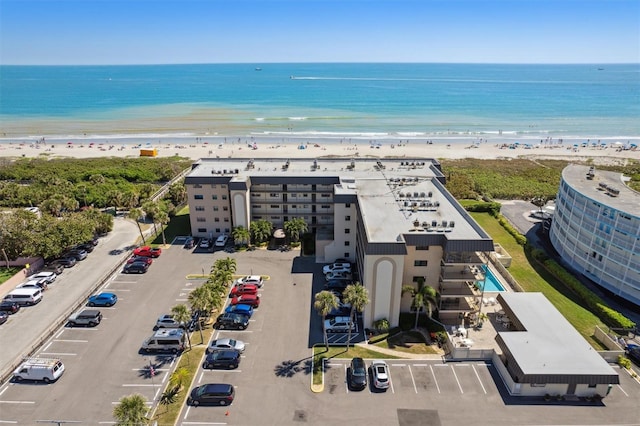 birds eye view of property featuring a view of the beach and a water view