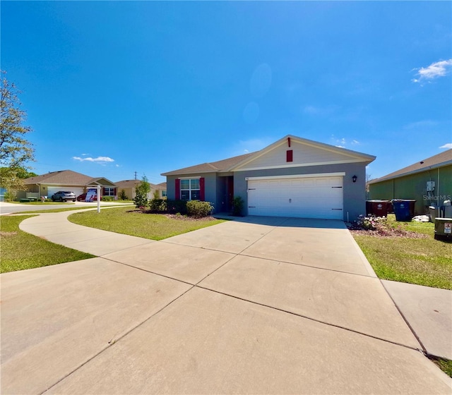 ranch-style house with a front lawn, concrete driveway, and a garage