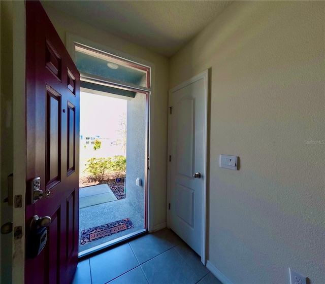 foyer entrance with light tile patterned flooring