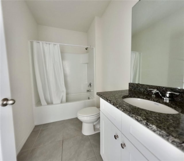 full bath featuring tile patterned floors, shower / tub combo with curtain, toilet, and vanity