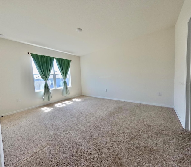 empty room with carpet flooring and baseboards