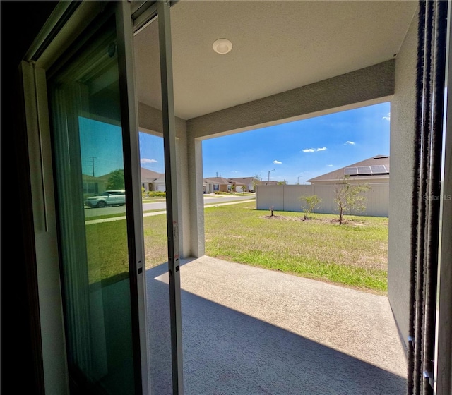 view of patio / terrace featuring a residential view and fence