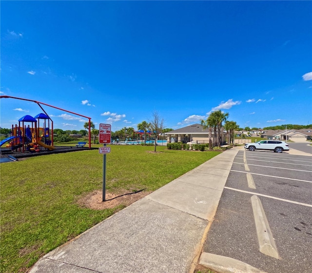 exterior space featuring a lawn and playground community