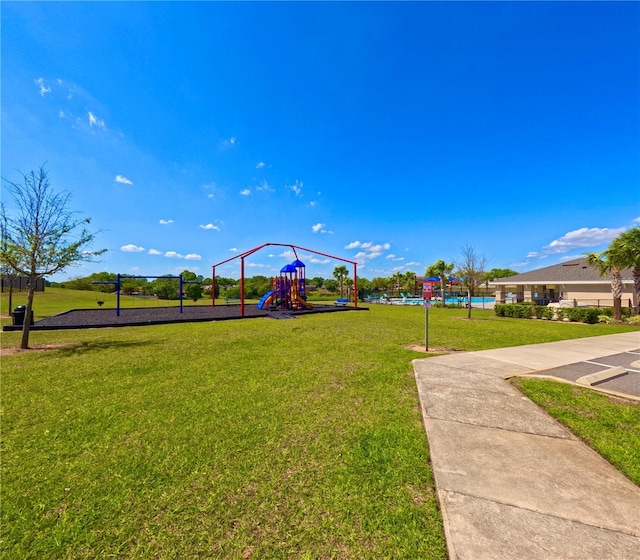 view of property's community with a yard and playground community