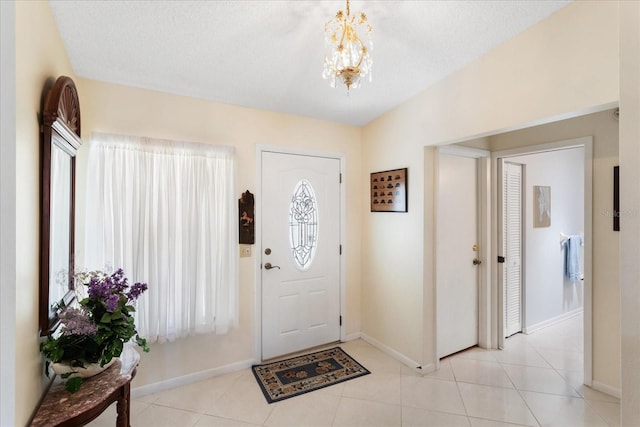3748 Innisbrook Dr, Lakeland, FL 33810 - foyer entrance with a chandelier, baseboards, and light tile patterned flooring
