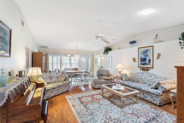 3748 Innisbrook Dr, Lakeland, FL 33810 - living area with lofted ceiling, ceiling fan, wood finished floors, and a chandelier