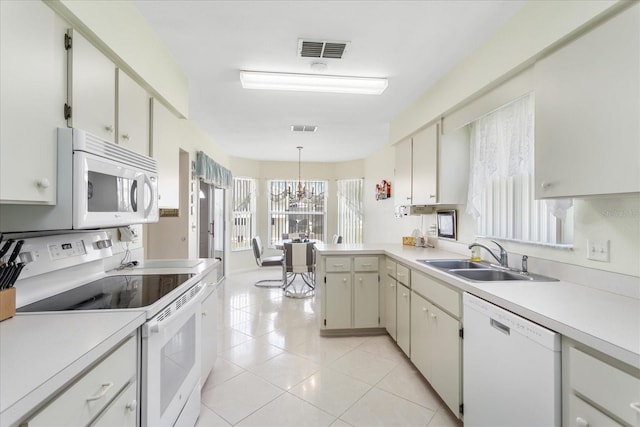 3748 Innisbrook Dr, Lakeland, FL 33810 - kitchen with white appliances, a sink, light countertops, a chandelier, and decorative light fixtures