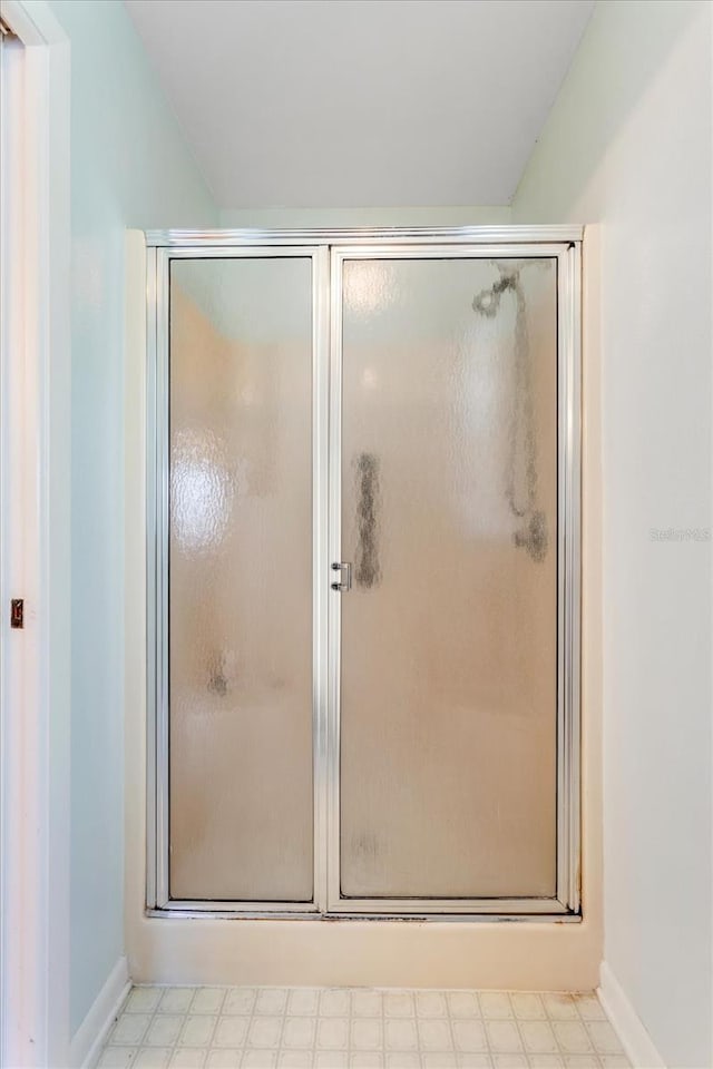 3748 Innisbrook Dr, Lakeland, FL 33810 - full bath featuring a shower stall, tile patterned floors, and baseboards