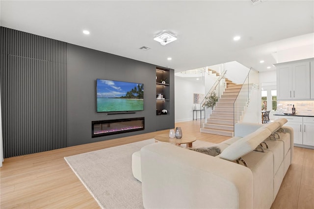 16689 Broadwater Ave, Winter Garden, FL 34787 - living area with recessed lighting, stairs, visible vents, and light wood-type flooring