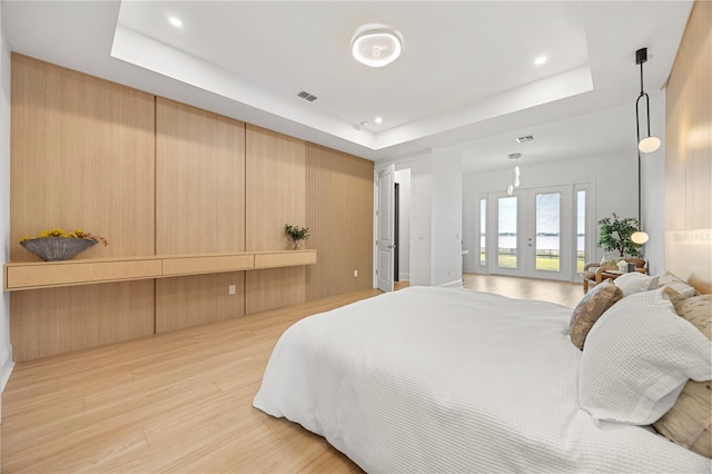 16689 Broadwater Ave, Winter Garden, FL 34787 - bedroom with light wood-type flooring, visible vents, recessed lighting, access to outside, and a raised ceiling