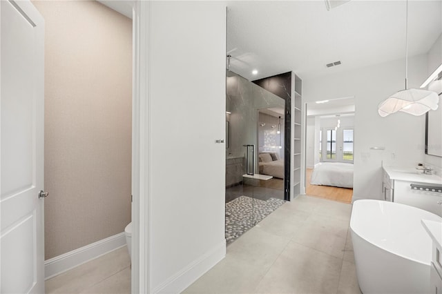 16689 Broadwater Ave, Winter Garden, FL 34787 - bathroom featuring vanity, toilet, visible vents, a freestanding tub, and ensuite bath