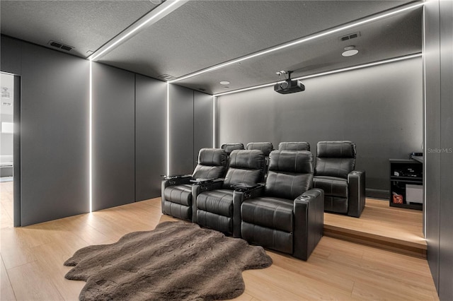 16689 Broadwater Ave, Winter Garden, FL 34787 - home theater featuring visible vents, a textured ceiling, and light wood finished floors