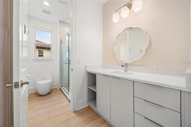 16689 Broadwater Ave, Winter Garden, FL 34787 - full bathroom featuring baseboards, visible vents, wood finished floors, a shower stall, and vanity
