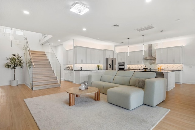 16689 Broadwater Ave, Winter Garden, FL 34787 - living area featuring recessed lighting, stairs, visible vents, and light wood-style floors
