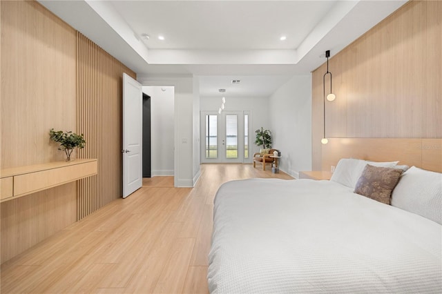 16689 Broadwater Ave, Winter Garden, FL 34787 - bedroom featuring a tray ceiling, light wood-type flooring, and recessed lighting